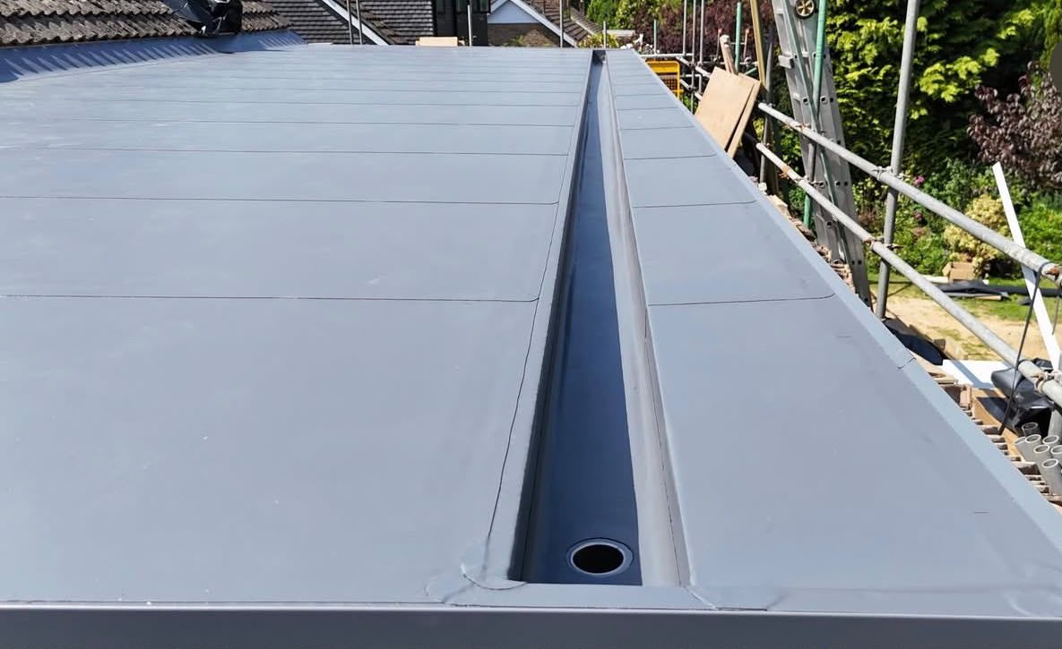 Flat roof drainage channel and outlet kept clear by Platinum Flat Roofing, project photograph 1